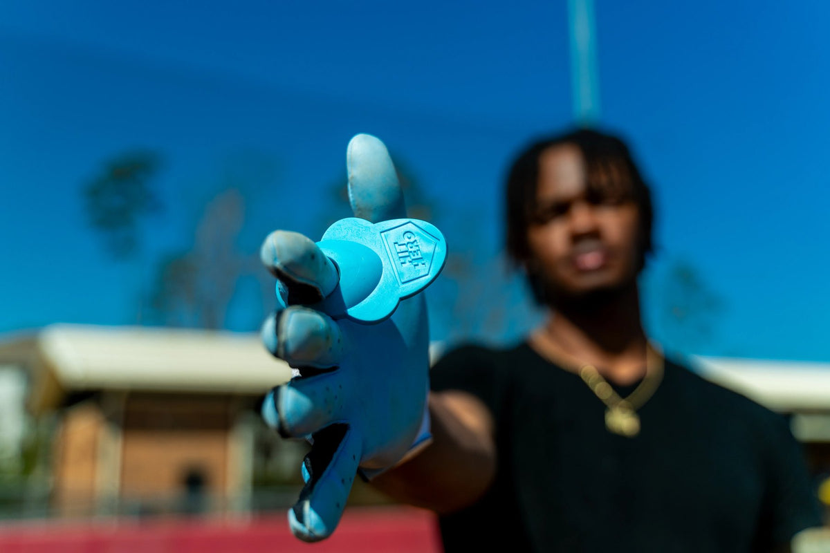 Blue Hit Hero guard worn on the hand, held out toward the camera